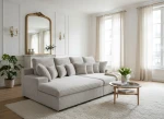 Elegantes Wohnzimmer-Ambiente mit dem hellgrauen Lounge-Sofa LAZY aus warmem Tilia 11 Cordstoff neben einer Zimmerpflanze.