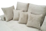Nahaufnahme der weichen Rücken- und Dekokissen des Sofas LAZY, welche die dicke, gerippte Struktur des Tilia Cordstoffes deutlich macht.