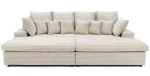 Freigestellte Frontalansicht des großzügigen Big Sofas LAZY im beigen Breitcord Tilia, komplett mit vielen gemütlichen Kissen.