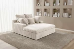 Gemütliche Wohnzimmer-Einrichtung mit dem beigen Cord-Loveseat LAZY ONE, platziert auf einem weichen Teppich vor einer beleuchteten Regalwand.
