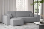 Graues U-Form Sofa KARL L aus elegantem Bouclé-Gewebe in einem zeitgenössischen Wohnzimmer mit stilvollem Couchtisch.