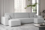 Stilvolles Wohnambiente mit dem hellgrauen XXL-Sofa KARL U im flauschigen Bouclé-Bezug Abriamo und minimalistischer Dekoration.