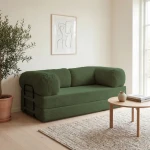 Gemütliches Schlafsofa MUNO aus Poso Cord Stoff mit den Maßen 200x100 cm, stilvoll arrangiert in einem hellen Wohnzimmer.