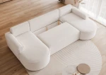 Detailansicht der gemütlichen Kissen und der Rückenlehne des 316x157 cm großen Sofas Sofia U im hochwertigen Riviera Velour und Abriamo Boucle Design.