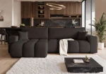 Frontalansicht des Design Ecksofas OFI XL (278x145 cm) mit weichem Bouclé-Bezug, stilvoll arrangiert in einem modernen Wohnzimmer.