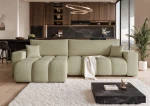 Frontalansicht des Design Ecksofas OFI XL (278x145 cm) mit weichem Bouclé-Bezug, stilvoll arrangiert in einem modernen Wohnzimmer.
