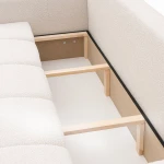 Das ausgeklappte Schlafsofa BUENO (239x91 cm) aus Bouclé-Stoff mit geöffnetem, integriertem Bettkasten für zusätzlichen Stauraum.