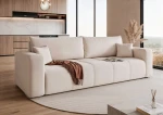 Schräge Ansicht des Sofas PEDRO (244x93 cm) mit weichem Manila Samtstoff, stilvoll arrangiert und integriert in eine gemütliche Wohnumgebung.