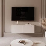Frontalansicht des Hänge-TV-Boards ANGEL 100 mit stimmungsvoller LED-Beleuchtung, stilvoll arrangiert in einem modernen Wohnzimmer.