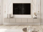 Frontalansicht des hängenden TV-Lowboards ANGEL (300 cm) mit stilvollen geriffelten Fronten und stimmungsvoller LED-Beleuchtung, arrangiert in einem modernen Wohnzimmer.