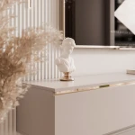 Nahaufnahme des hängenden TV-Lowboards SELIA, welche die eleganten Goldakzente und die feine kaschmirfarbene Oberfläche im Detail präsentiert.
