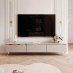 Frontalansicht des stehenden TV-Lowboards SELIA (200 cm) in Kaschmir mit eleganten goldenen Füßen, stilvoll arrangiert in einem modernen Wohnzimmer.