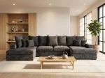 Frontalansicht der großen Wohnlandschaft SELLO in U-Form mit weichem Bezug aus Flow (Chenille), stilvoll arrangiert in einem geräumigen Wohnzimmer.