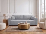 Das elegante Schlafsofa Capri im hellgrauen Cordstoff Poso 55, stilvoll arrangiert in einem lichtdurchfluteten, modernen Wohnzimmer.